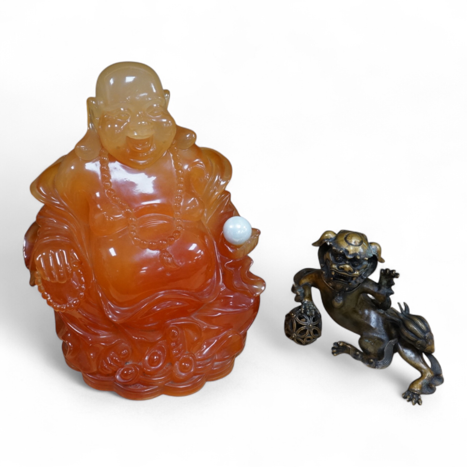 A resin model of a seated buddha, and a brass recumbent lion dog, Buddha 35cm high. Condition - fair